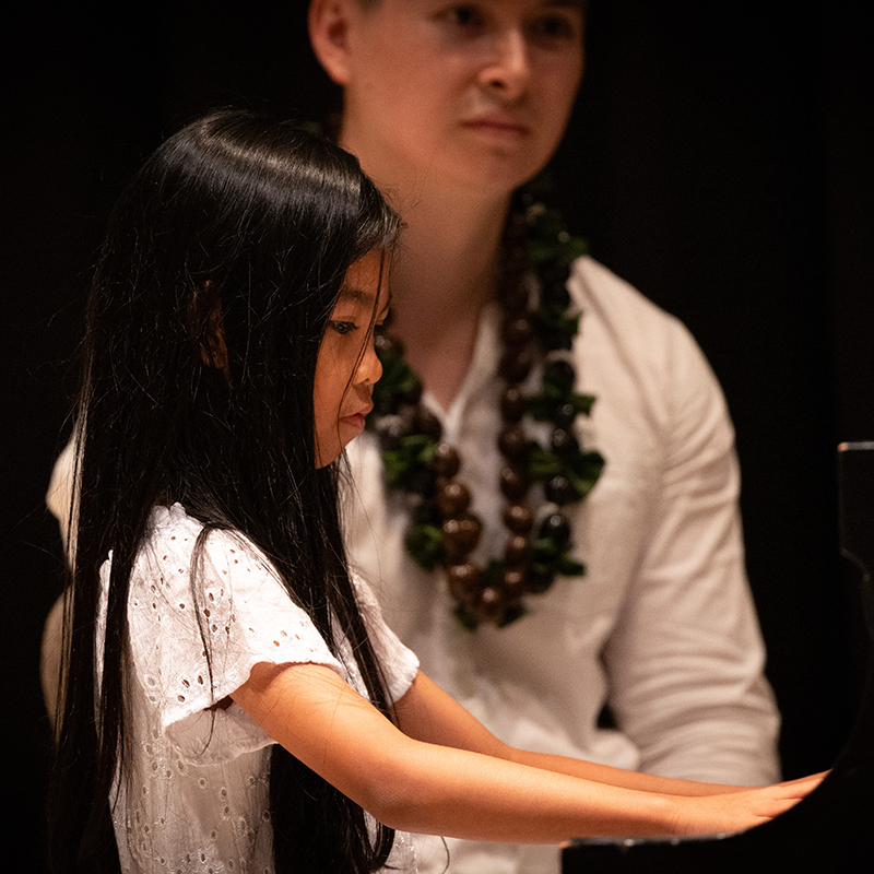 image of piano teacher ian Shanks with young student during recital